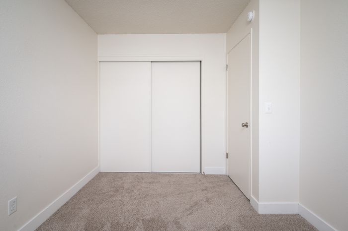 bedroom with carpet and sliding door closet