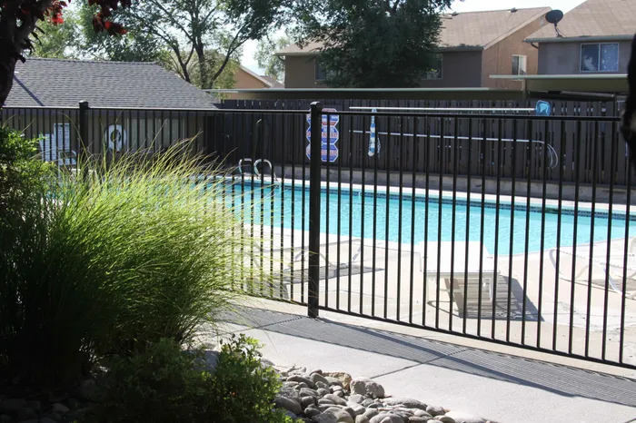 pool with fence and walkway at plumas garden apartments