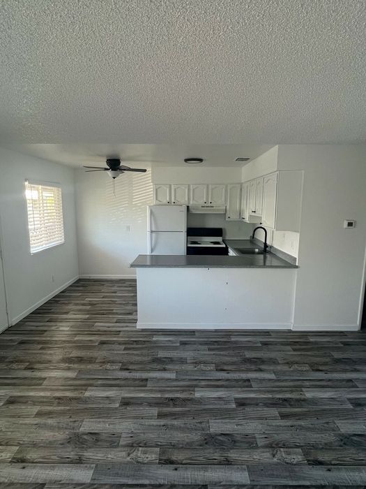 living room, kitchen and dinning area with wood inspired vinyl flooring at the creek at south carson