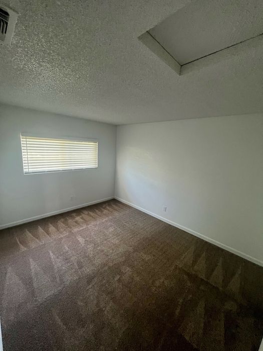 bedroom with brown carpet at the creek at south carson