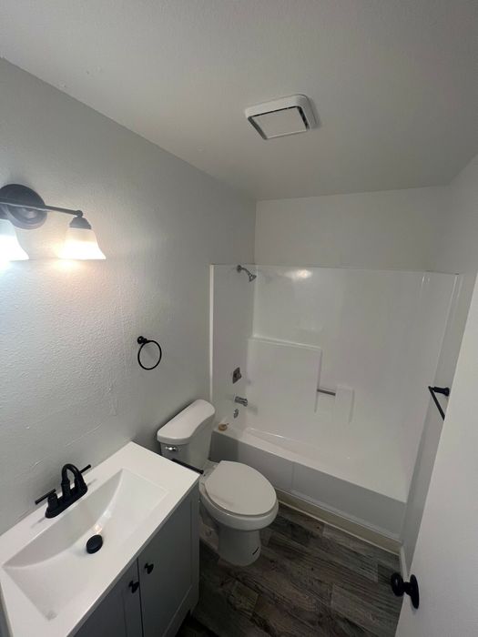 full bathroom with shower-tub combo and white vanity at the creek at south carson