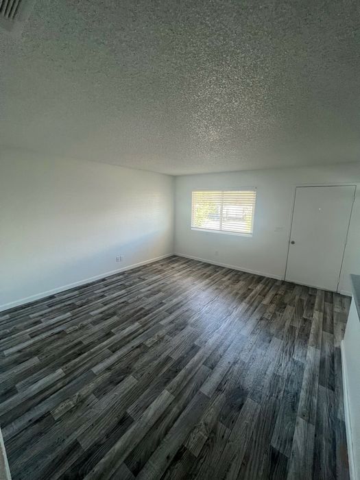 living room and main entrance with wood inspired laminate flooring at the creek at south carson