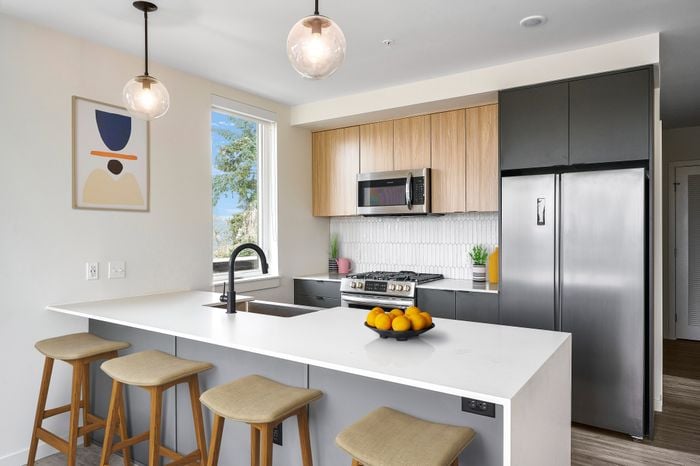 Apartments in Woodstock for Rent - Novus - Kitchen with Island, Stainless-Steel Appliances, and Hanging Light Fixtures
