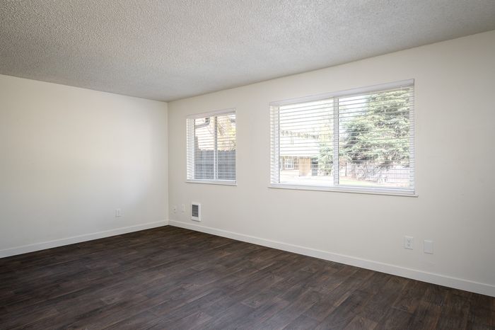 Spacious living room with large windows and Vinyl Wood Like Flooring