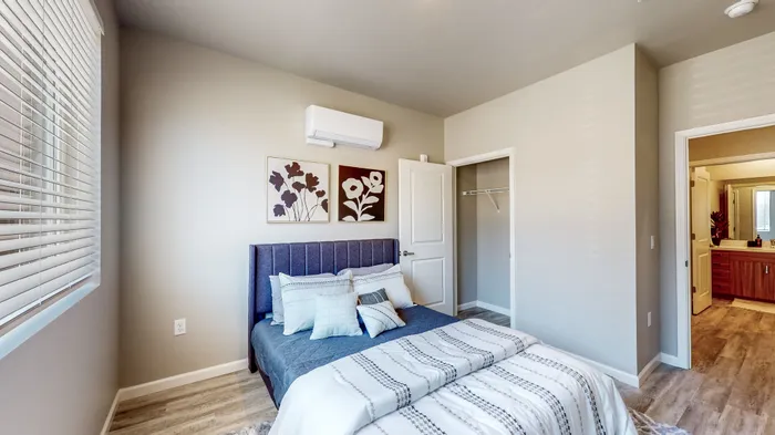 Bedroom with vinyl plank flooring and large windows