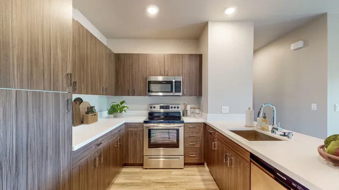1-Bedroom Apartments In Reno, NV - Canyon's Edge - Modern Kitchen With Hardwood Cabinets, Stainless-Steel Appliances, And Wood-Inspired Flooring