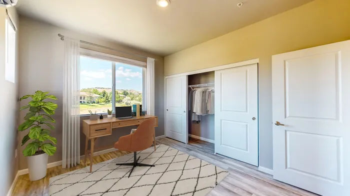 3-Bedroom Apartments In Reno, NV - Canyon's Edge - Spacious Bedroom With Wood-Inspired Flooring, Windows For Natural Light & A Premium View, And A Closet With Sliding Doors