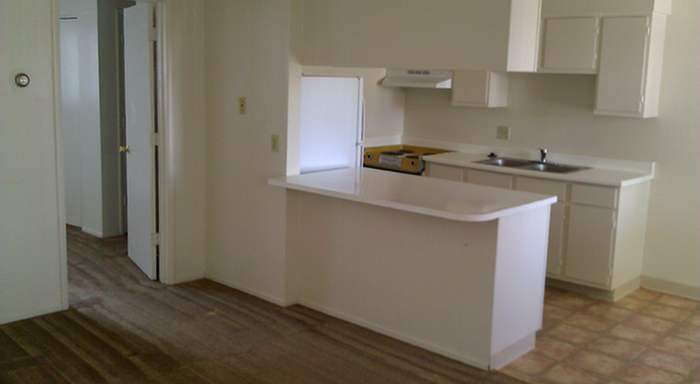 kitchen with a breakfast bar at palace apartments