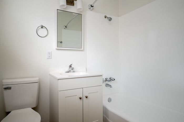 Bathroom with sink toilet and dual shower bathtub
