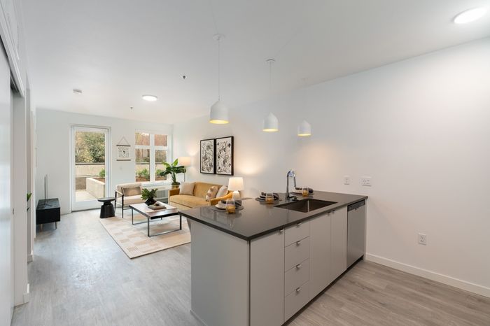 open floor plan with faux hardwood floors and quartz countertops