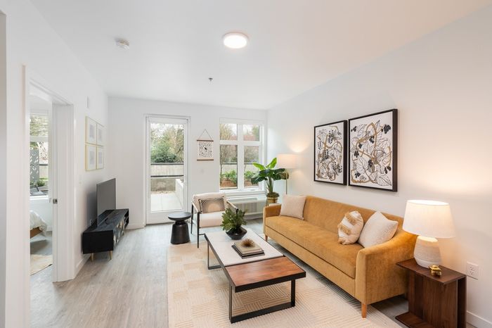 living room with brown leather sofa coffee table and access to patio