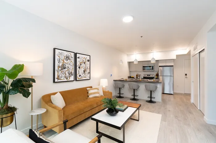 living room with brown leather sofa coffee table and open floor plan