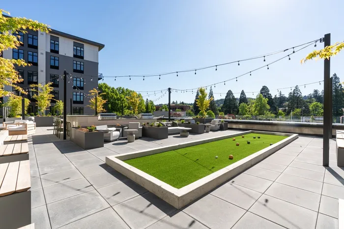 Outdoor community patio with bocce court at Henley Place