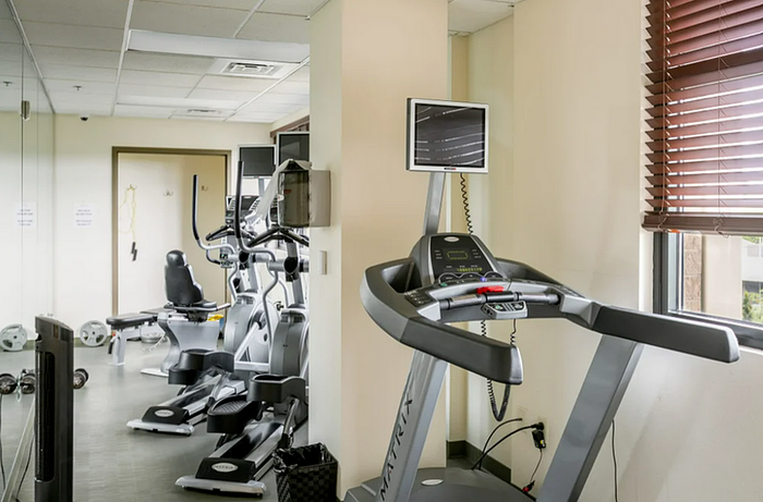 fitness center with treadmills and elipticals