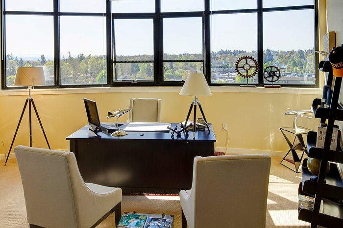 office with desk and decorative accessories and two beige chairs