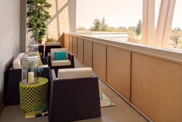 patio with outdoor armchairs and side tables