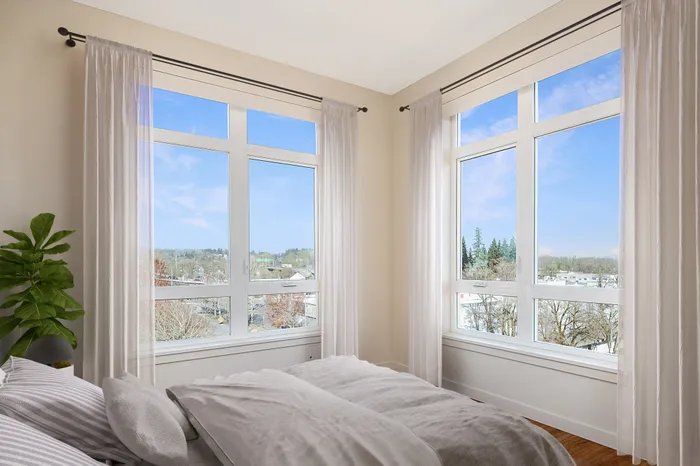 virtually staged bedroom with oversized windows adding to the natural light