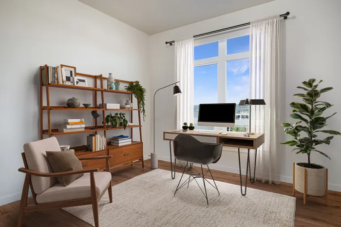 Virtually staged office featuring a large window allowing natural light and luxury vinyl plank flooring