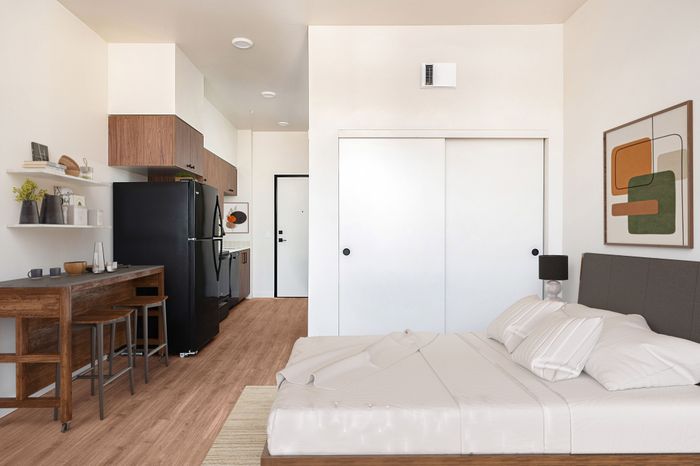 Studio apartment at Rivenwood in Salem OR featuring wood-style cabinetry, luxury vinyl plank flooring, and brand-new appliances.
