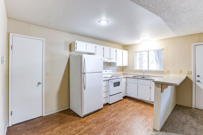Full kitchen with fridge, oven and sink