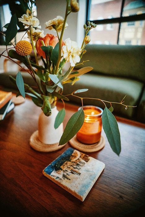 up close to a decorative plant on a coffee table and green sofa in the back