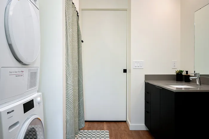 Bathroom with full sized washer and dryer