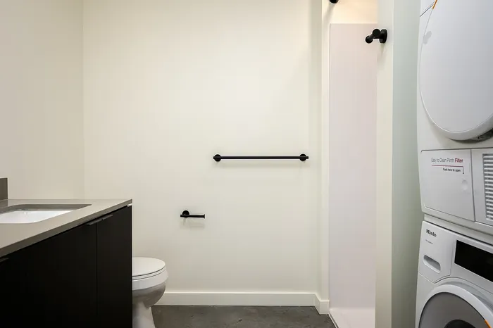 Bathroom with full sized washer dryer