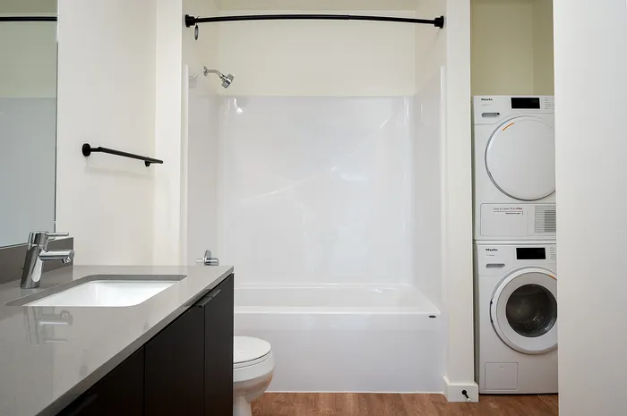 Bathroom with full sized washer and dryer