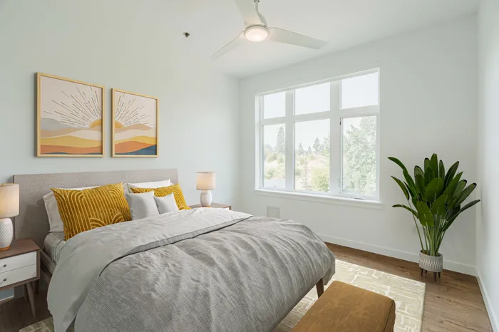 bedroom with wood floor, ceiling fan and window