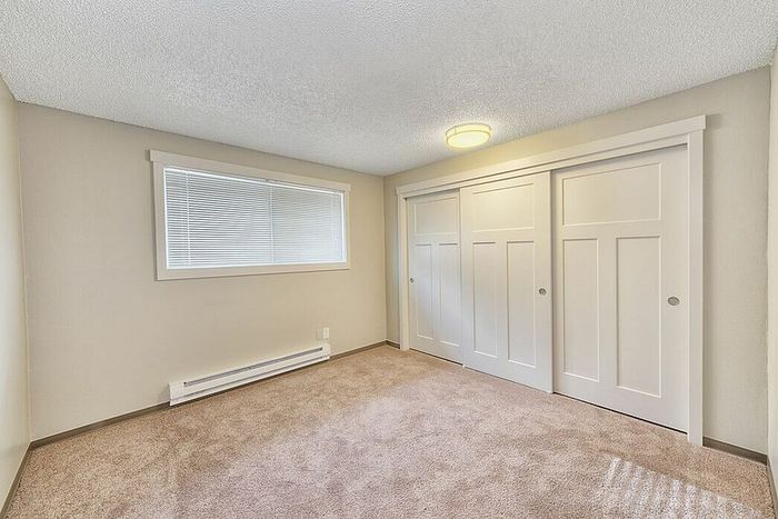 bedroom with large sliding door closet at quad apartments
