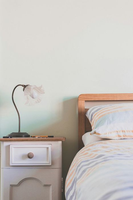 bed with side table and a lamp