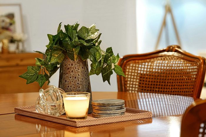 round wooden dinning table with decorative items in the center