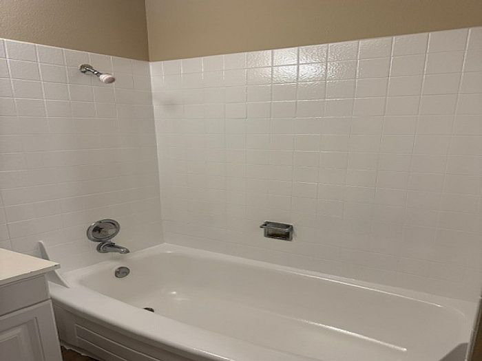 Bathroom with white tile shower and tub