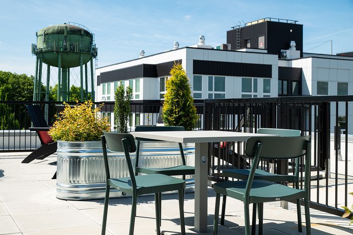 rooftop deck with lounge chairs, bbq grills, seating areas and panoramic portland, OR views