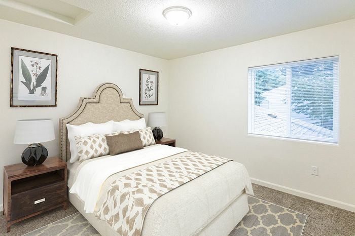 second bedroom with bed and side tables at fairview court
