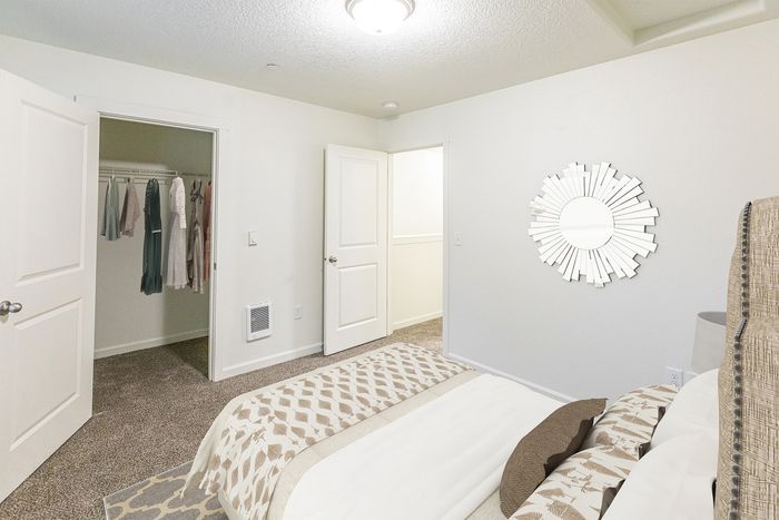 second bedroom with bed walk in closet at fairview court