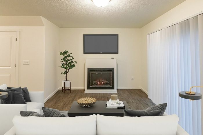 living room with wood like flooring and an electric fireplace at fairview court