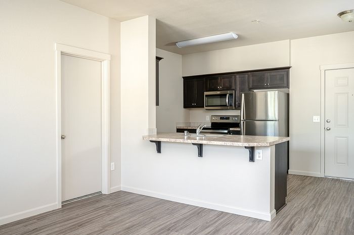 Kitchen at Alderbrook with stainless steel appliances and a breakfast bar