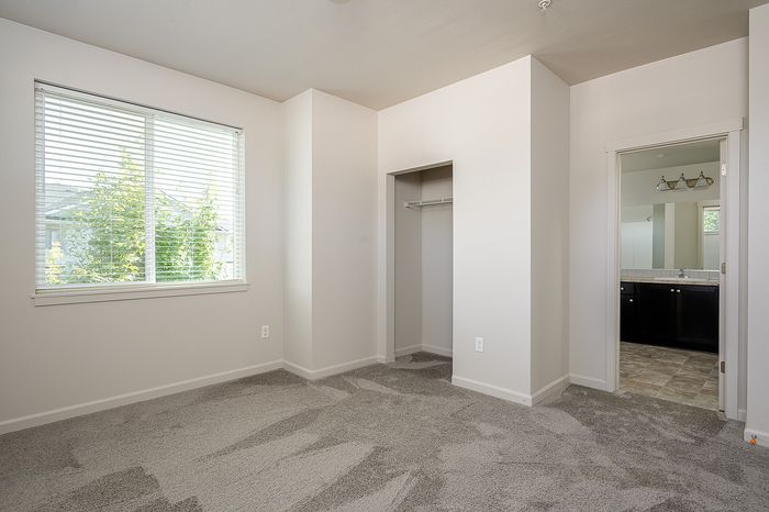 Carpeted bedroom at Alderbrook with en suite bathroom