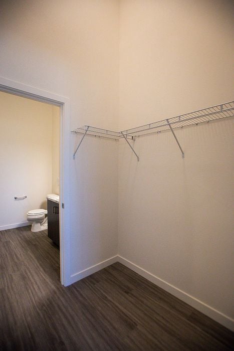 walk-in closet and bathroom with faux hardwood flooring at pacific ridge apartments