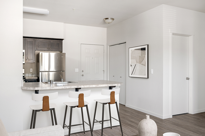 Virtually staged kitchen with breakfast bar at Alderbrook apartments in Vancouver, WA