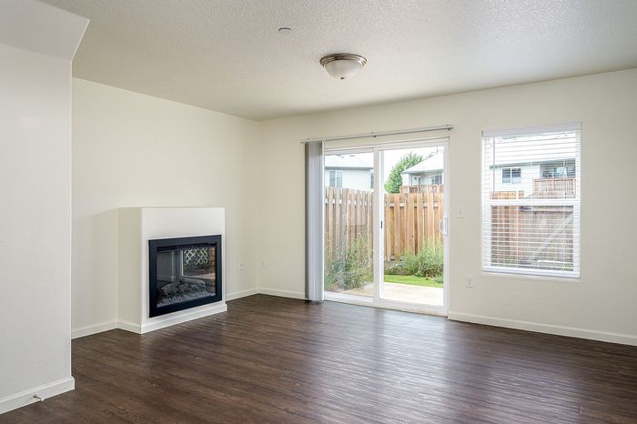 living area with fireplace and sliding glass doors leading to enclosed patio/yard