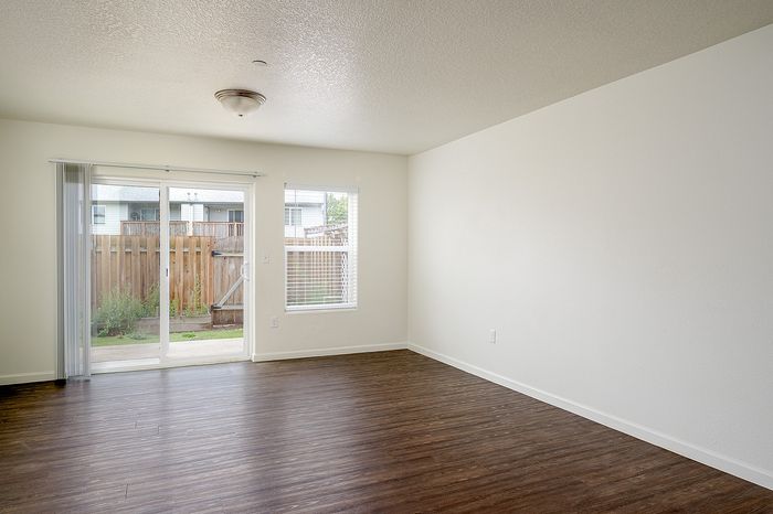 living area with fireplace and sliding glass doors leading to enclosed patio/yard