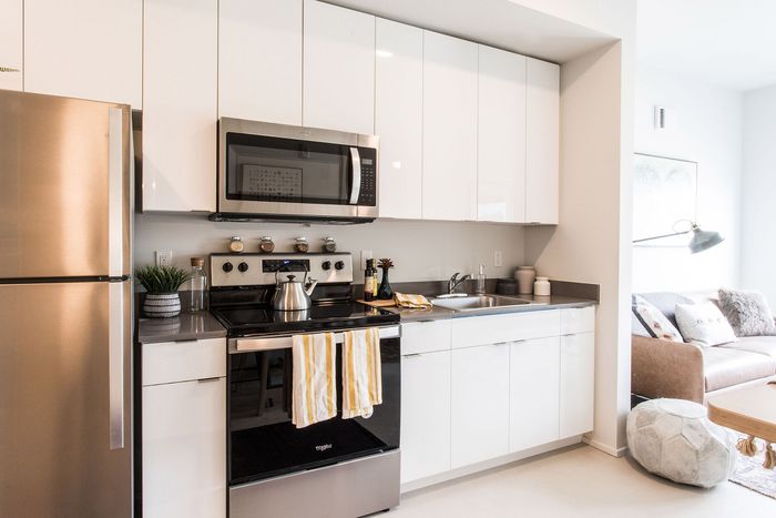 kitchen with stainless steel appliances and living room in the background