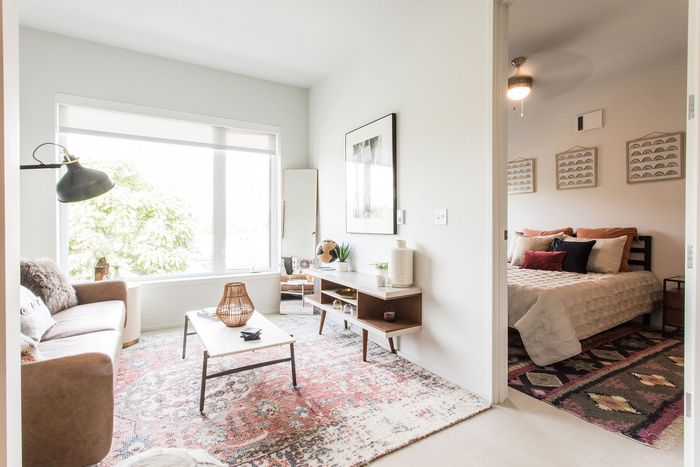 living room with leather sofa and large area rug with a coffee table