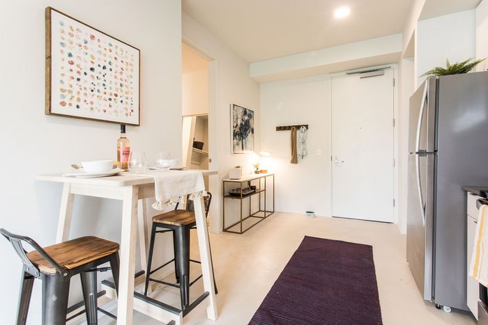 kitchen with stainless steel appliances and living room in the background