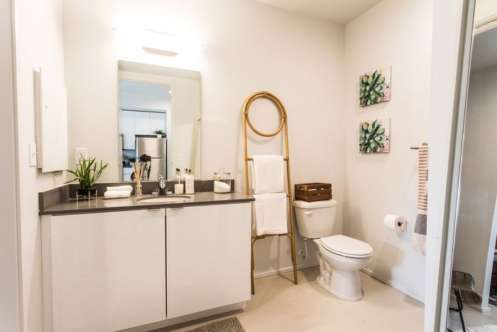 bathroom with quartz vanity and white cabinets
