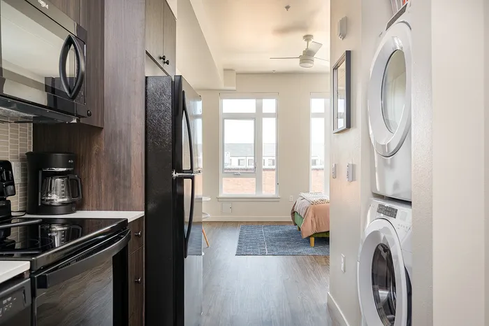 Fully Furnished Studio Floor Plan kitchen and in-home washer + dryer