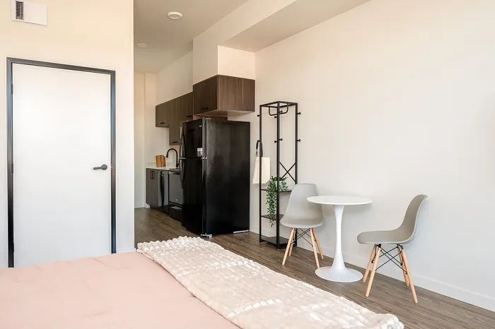 Fully Furnished Studio Floor Plan bed, kitchen, and living area