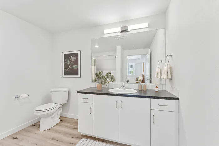 bathroom with shower/tub combo, white cabinets and grey countertops